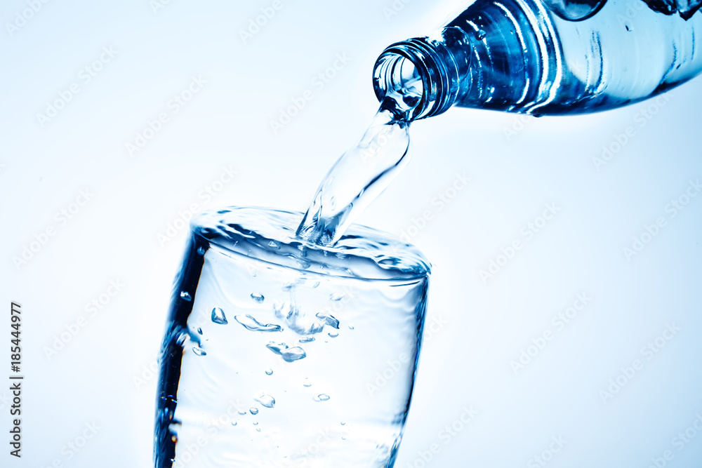 Fresh drinking water is poured in a glass. Fresh drinking water is poured in a glass.