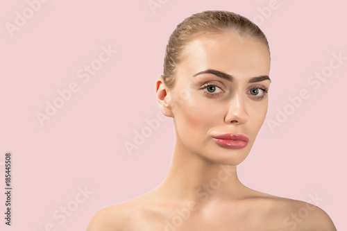 Portrait of a beautiful nude female girl model big lips on beige background spa