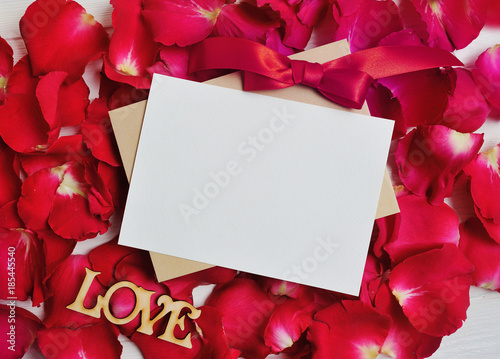 Mockup Card on red rose petals for Valentine's Day. Flat lay, top view with a place for your text