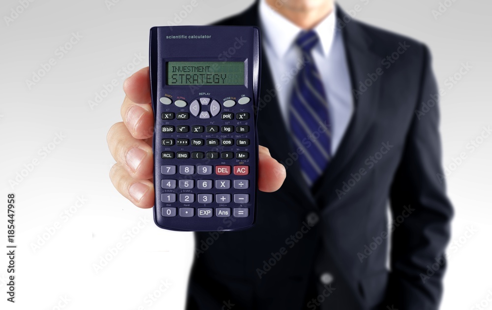 Men holding calculator showing investment strategy Men holding calculator showing investment strategy
