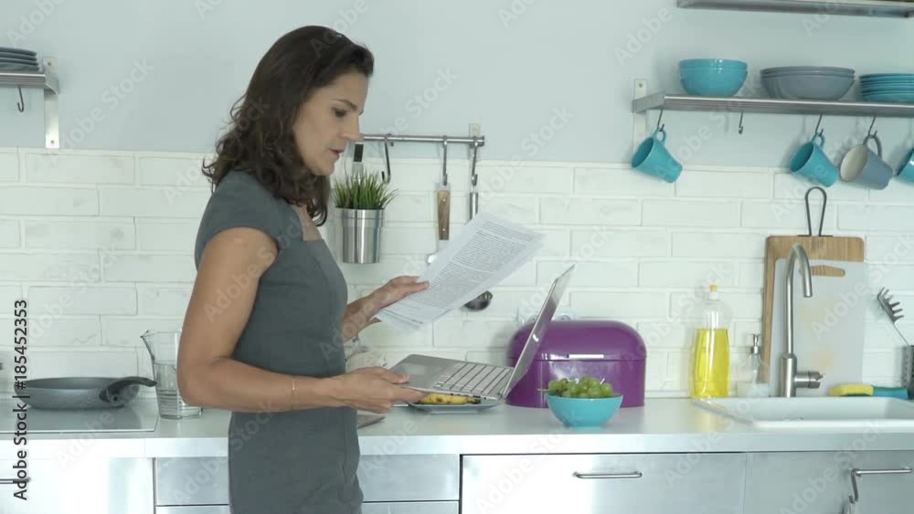 Unhappy, sad businesswoman working with laptop, documents and smartphone in kitchen
Unhappy, sad businesswoman working with laptop, documents and smartphone in kitchen