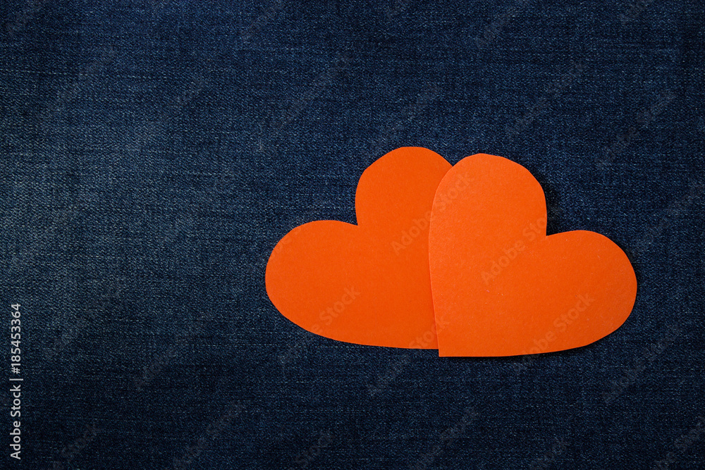 Obraz premium Two red hearts heart on denim background. Background Valentine's Day.