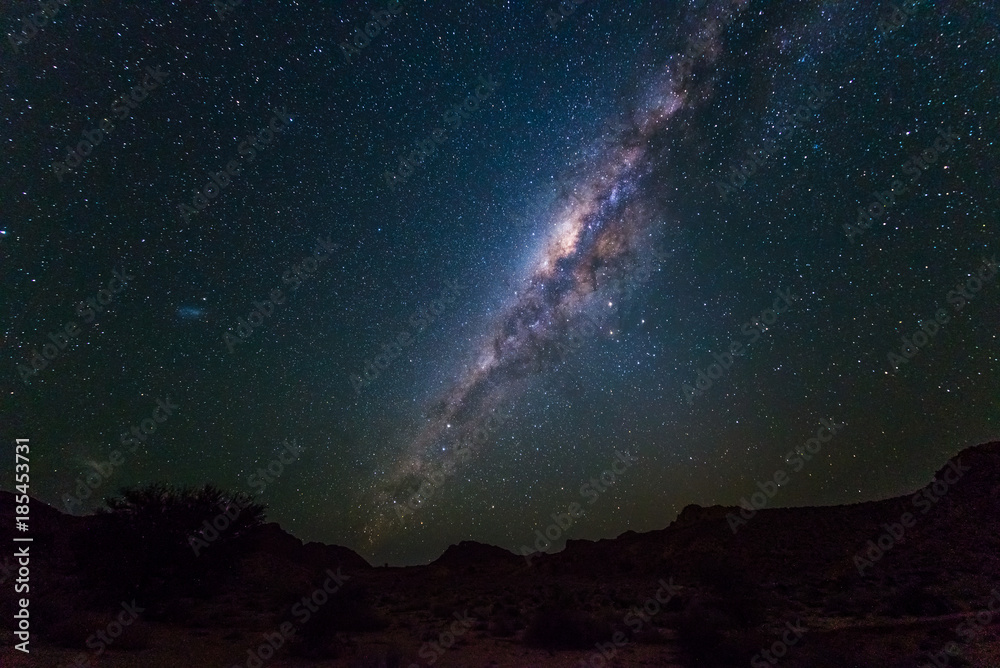 Milky Way arch, stars in the sky, the Namib desert in Namibia, Africa. The Small Magellanic Cloud on the left hand side.