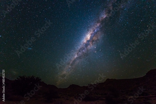 Milky Way arch  stars in the sky  the Namib desert in Namibia  Africa. The Small Magellanic Cloud on the left hand side.