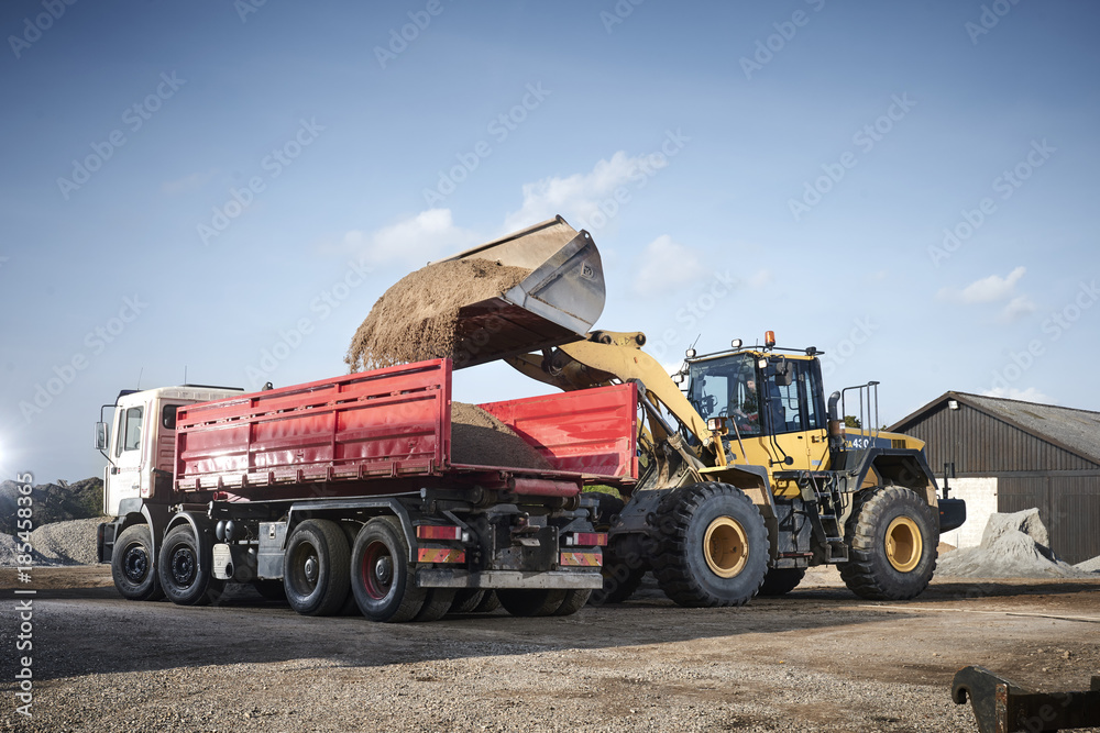 Excavator moving sand