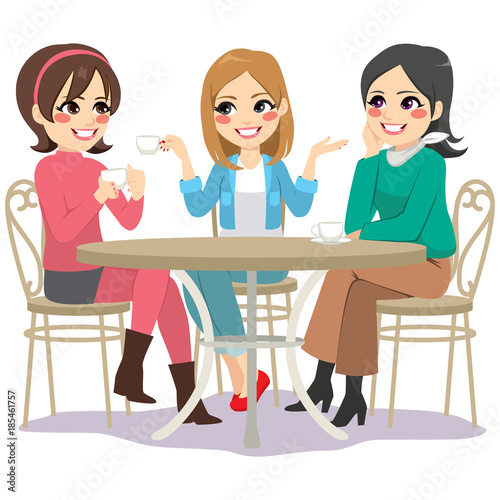 Three beautiful young women friends having coffee sitting at cafe table in street