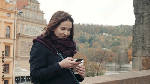 Beautiful Young Woman Tourist In Prague Using Her Smartphone, Travelling Concept