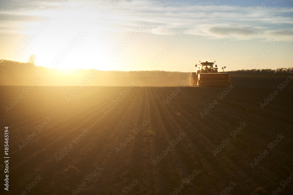 Red tractor plow field