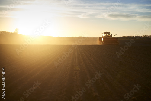 Red tractor plow field