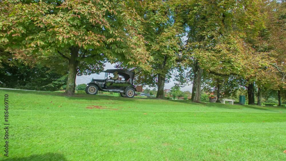 Driving with first wooden car through beautiful tree-lined alley that leads to an amazing and luxurious villa. Driving with first wooden car through beautiful tree-lined alley that leads to an amazing and luxurious villa.