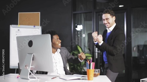 two employees raising hands when successfully closing big business deal