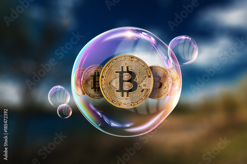 Gold Coins Bitcoin in a soap bubble. The concept of instability of the crypto currency, electronic money, the burning of the crypto currency. photo