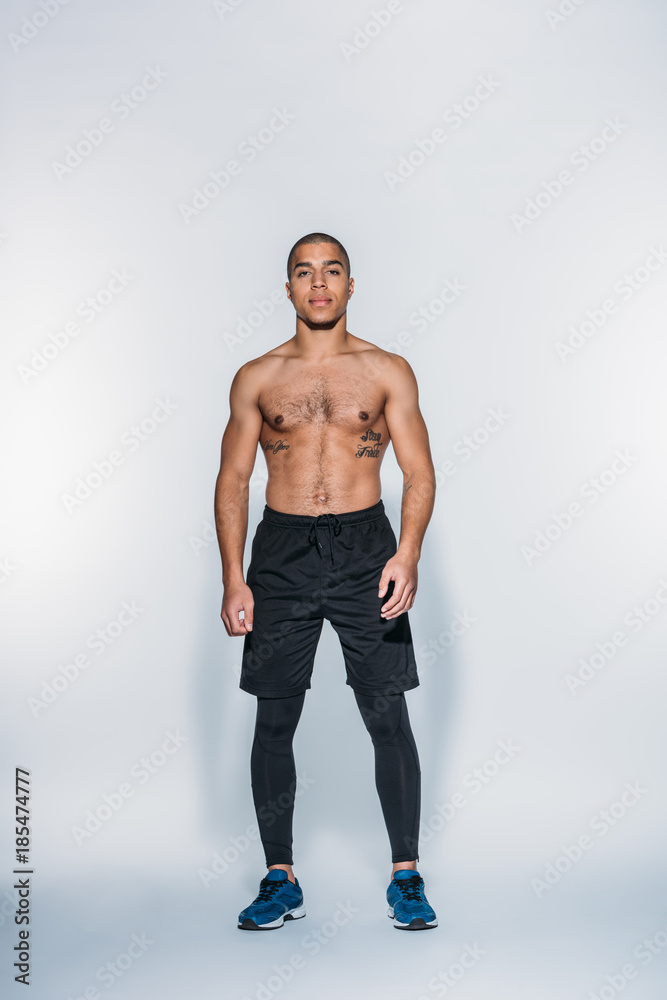handsome african american sportsman standing and looking at camera