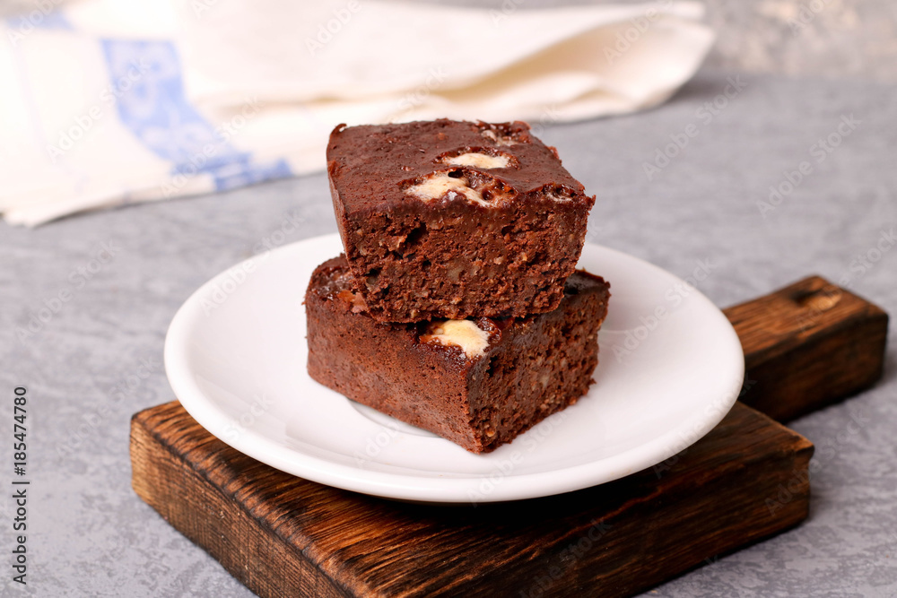 Homemade chocolate brownie on a white plate Homemade chocolate brownie on a white plate