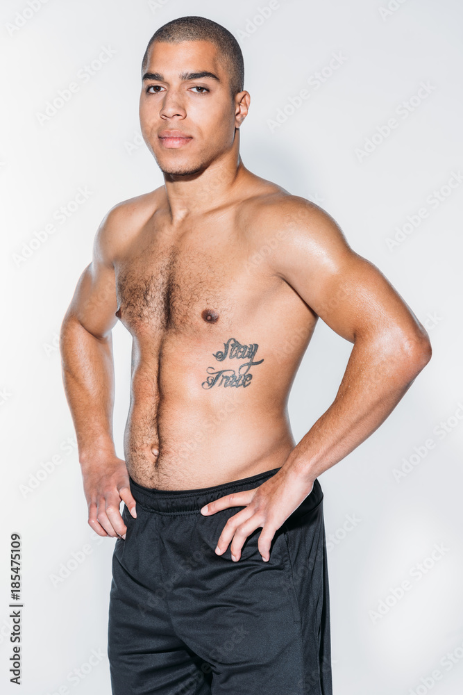tattooed african american sportsman standing isolated on white tattooed african american sportsman standing isolated on white