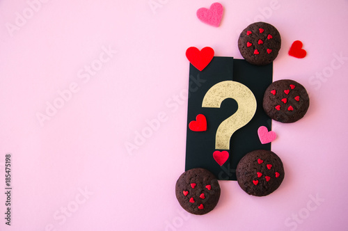 Chocolate cookies with hearts sugar on a pink background. Saint Valentie's Day concept. photo