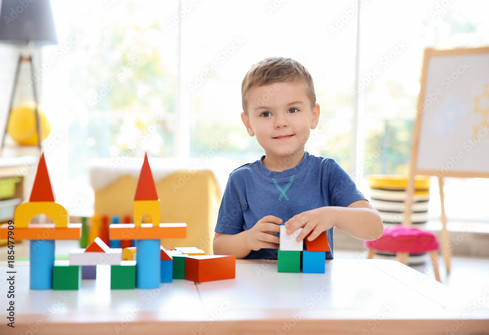 Cute little boy playing with blocks at home Cute little boy playing with blocks at home