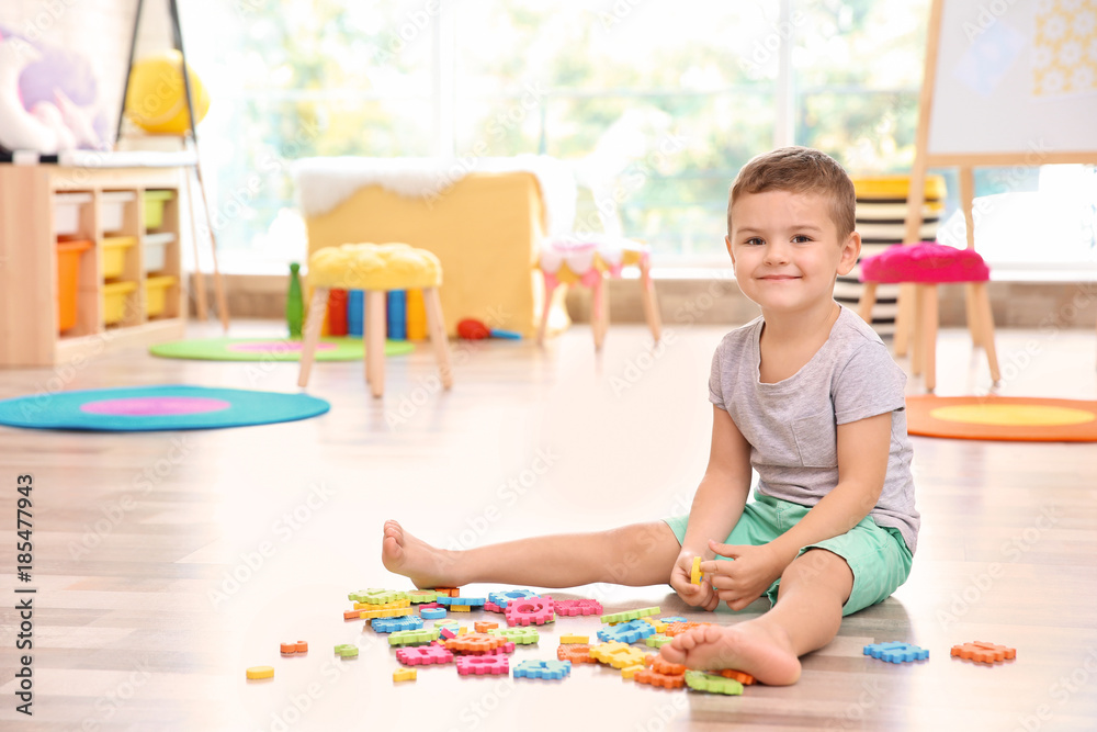 Cute little boy playing with math puzzle at home Cute little boy playing with math puzzle at home