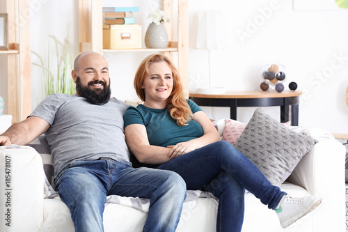 Overweight couple watching ...