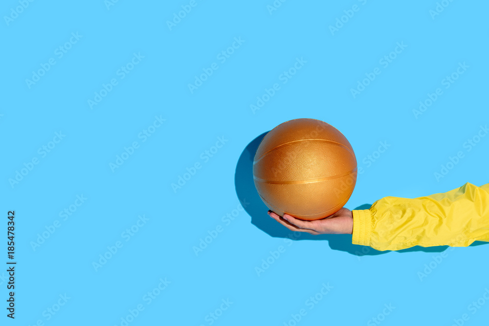 Cropped image of man hand with basketball ball in hand
