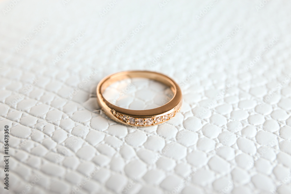 Beautiful engagement ring on textured background Beautiful engagement ring on textured background
