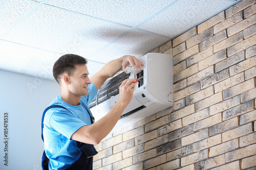 Male technician repairing c...