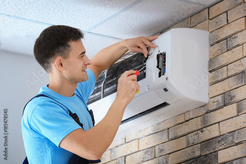 Male technician repairing c...