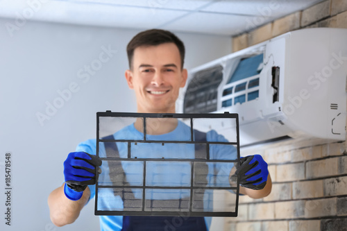 Male technician repairing c...