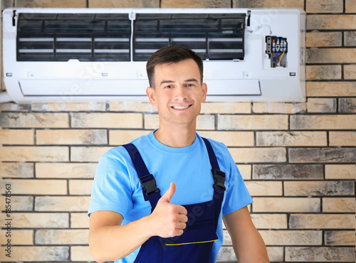 Male technician with repair...