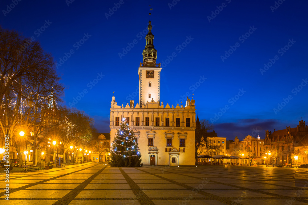 Old town square with historical town hall in Chelmno at night, Poland