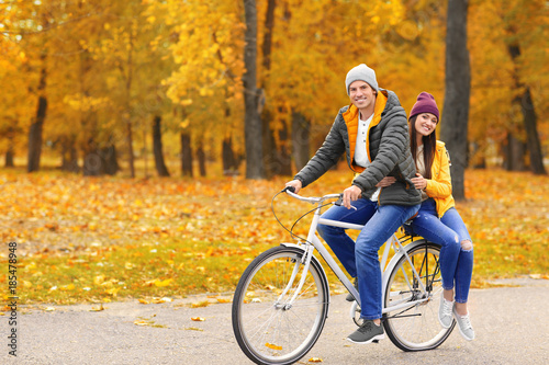 Young couple riding bicycle...