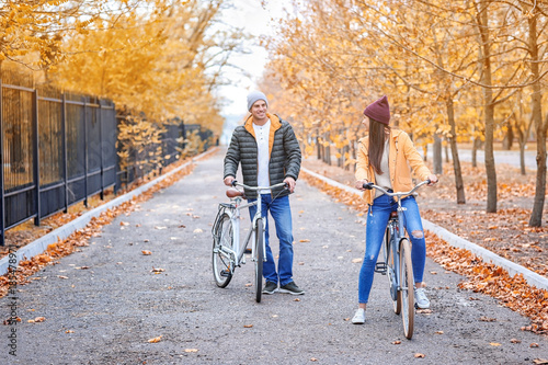 Young couple riding bicycle...