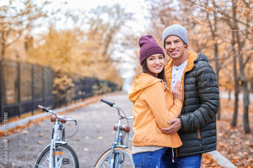 Young couple resting after bike ride in park