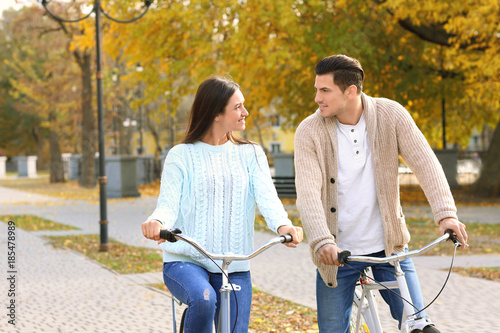 Young couple riding bicycle...