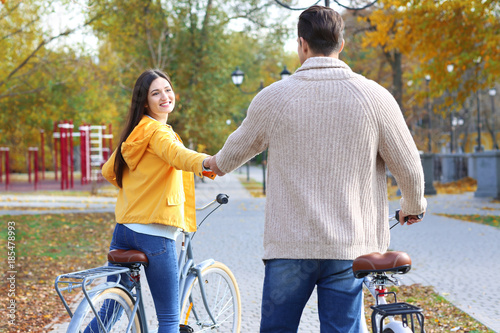 Young couple riding bicycle...