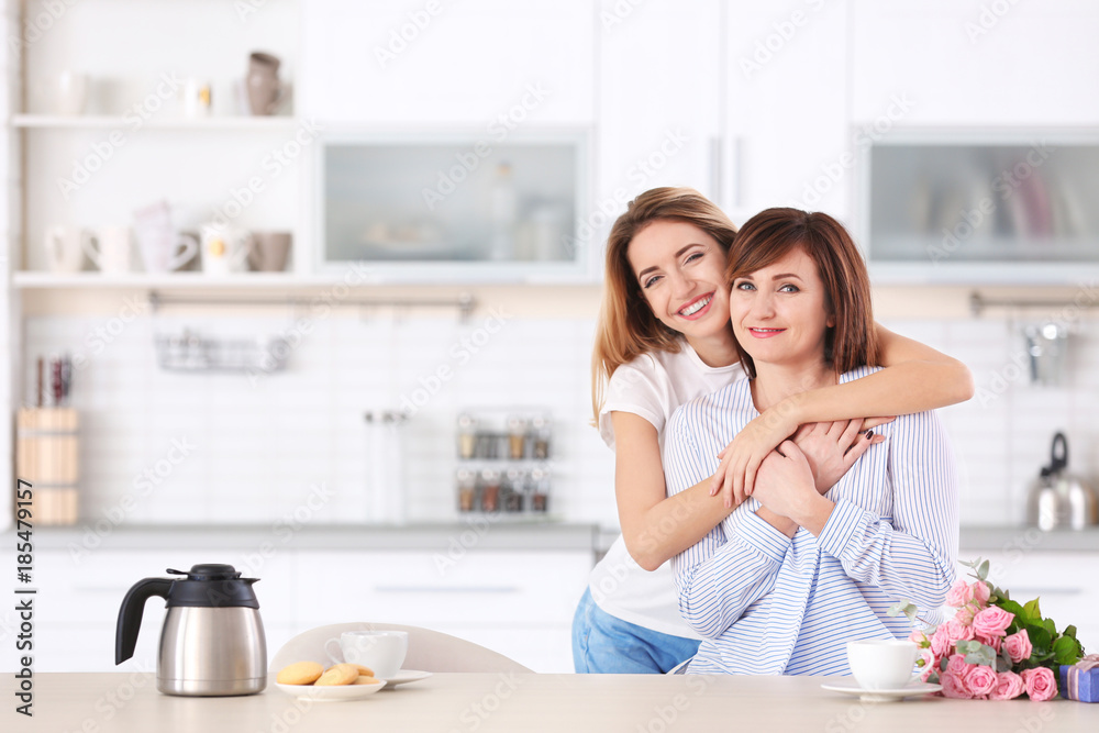 Attractive young woman with her mother at home