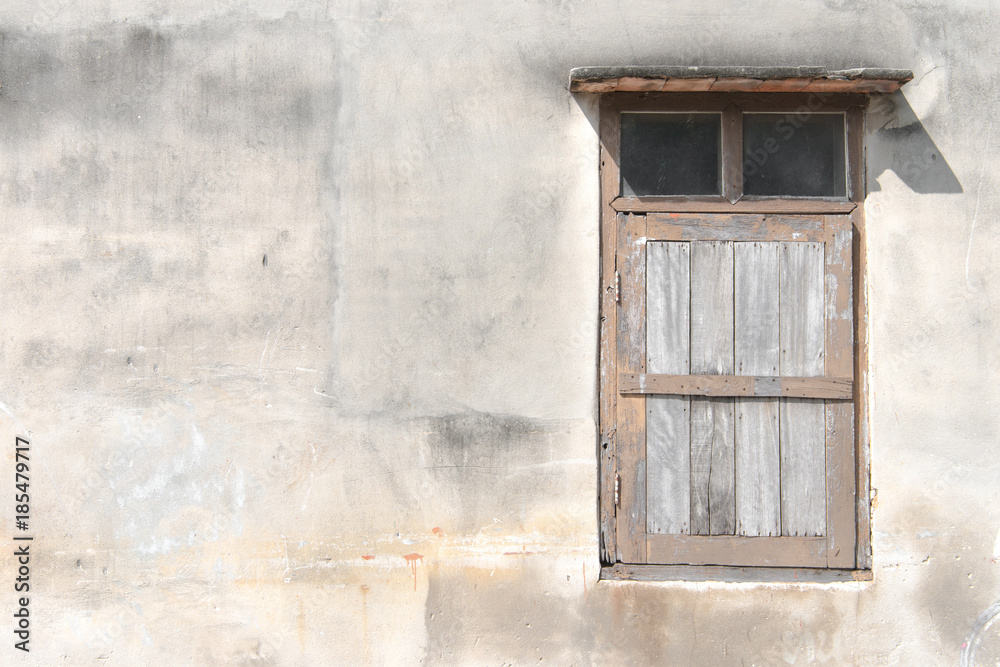 Old grunge wooden window isolated on cement wall