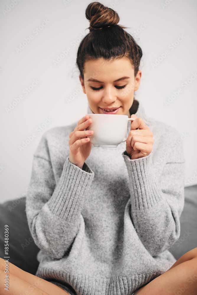 Portrait of woman drinking coffee in the morning while sitting on the bed Portrait of woman drinking coffee in the morning while sitting on the bed