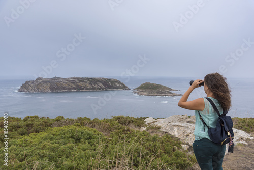 Girl with binoculars looking at Sisarga Islands (Malpica, La Coruna - Spain). © josfor