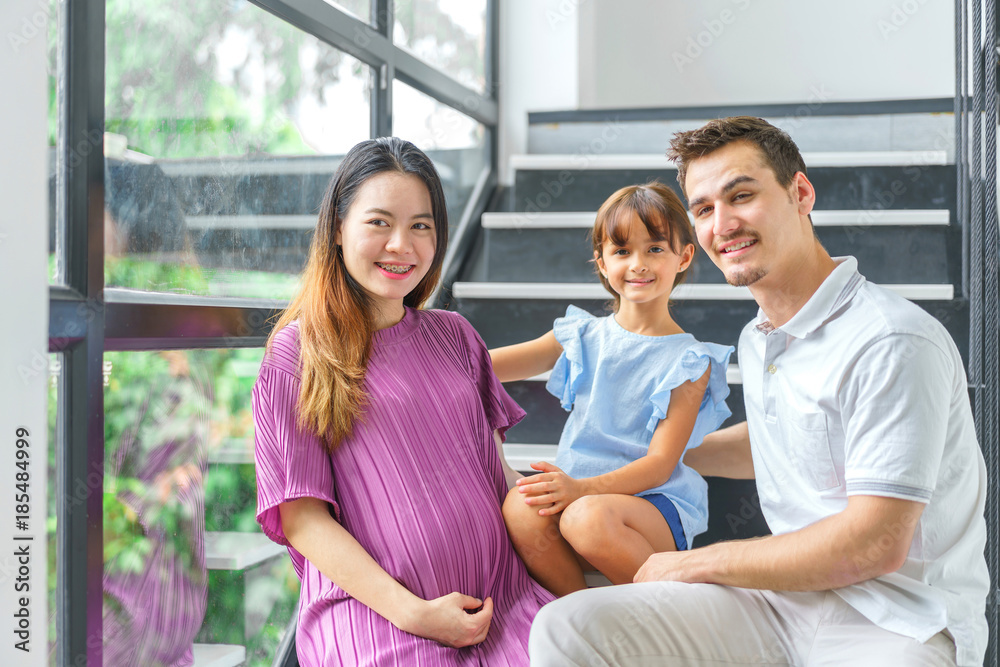 Three people of family, father, mother pregnant and duagther. concept of happy feeling and love relation. Three people of family, father, mother pregnant and duagther. concept of happy feeling and love relation.