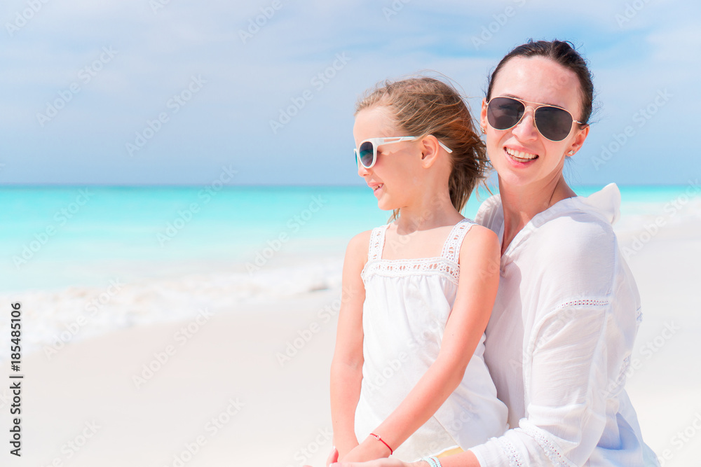 Little adorable girl and young mother at tropical beach Little adorable girl and young mother at tropical beach