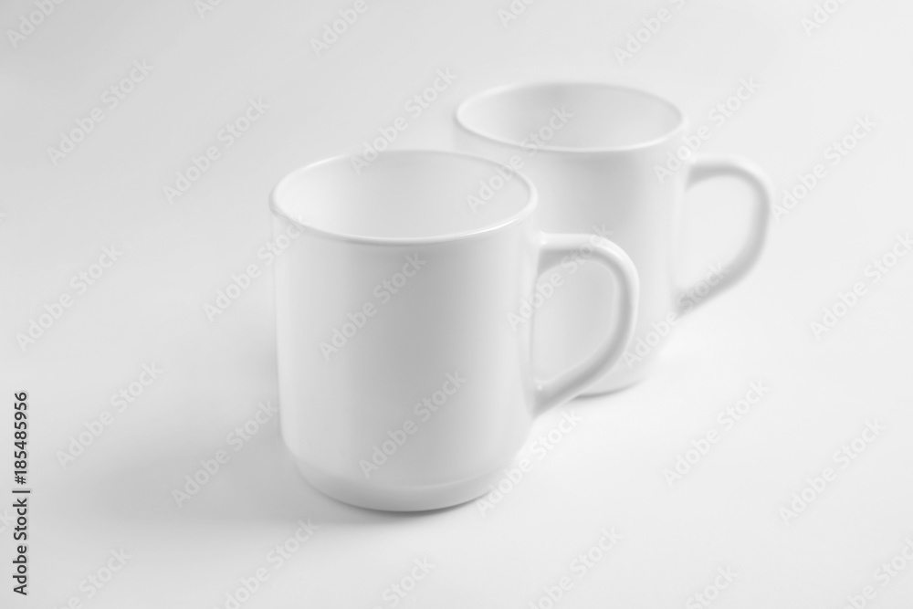 Fototapeta premium Ceramic cups on white background. Mockup for design