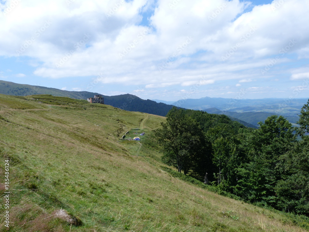 View of the mountain range against the background of the cloudy sky. View of the mountain range against the background of the cloudy sky.