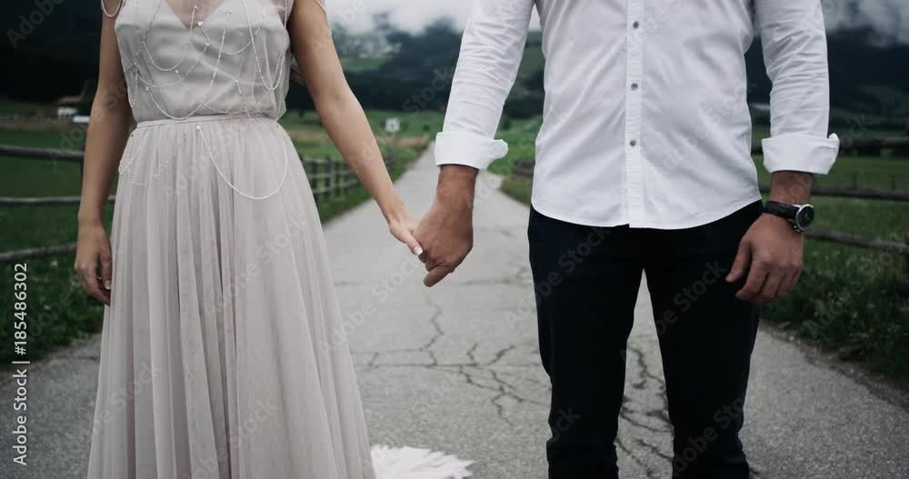 Closeup young couple dressed romantic are holding the hands of a each other background amazing nature view Closeup young couple dressed romantic are holding the hands of a each other background amazing nature view