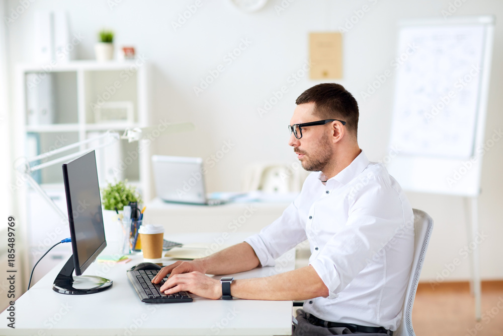 businessman typing on computer keyboard at office