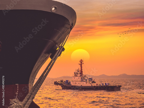 The vessel completed berth at industrial port on sunset,The tug departure after completed berth on sunset.