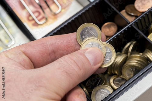 Cash register with coins and paper money