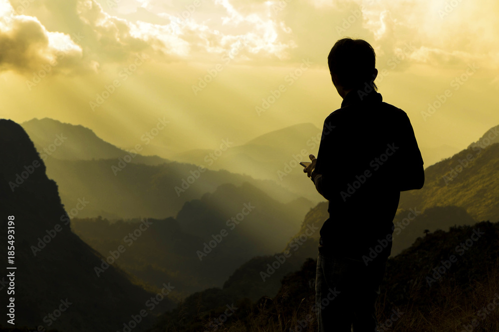 Silhouette of a man on top of mountain. Success and motivated concept