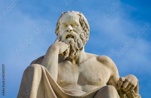 Greatest philosopher of ancient Greece Socrates reflects on the meaning of life, on the background of blue sky.