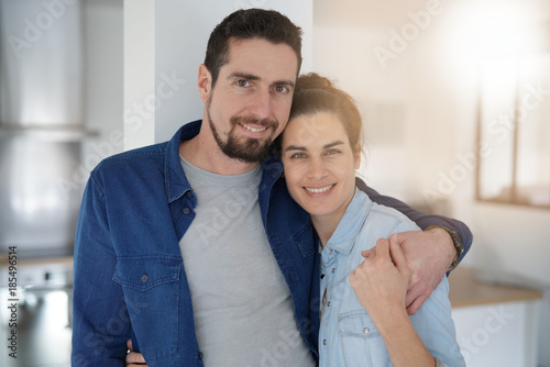 Middle-aged couple standing together in home kitchen © goodluz